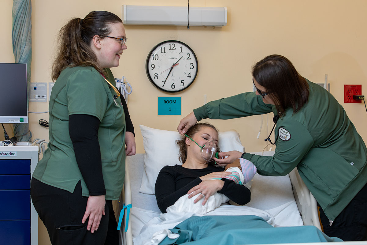 Student Nurses practicing caring for a new mother and her baby