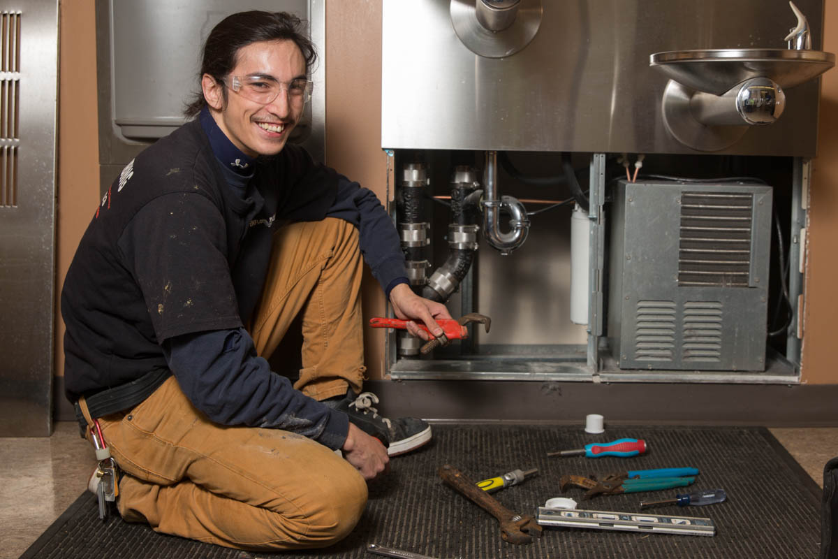 Man working on industrial plumbing