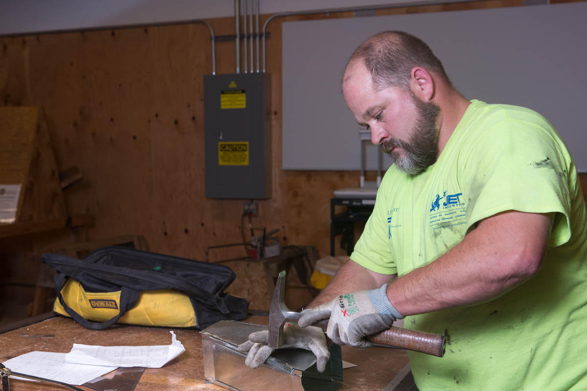 Man building HVAC venting