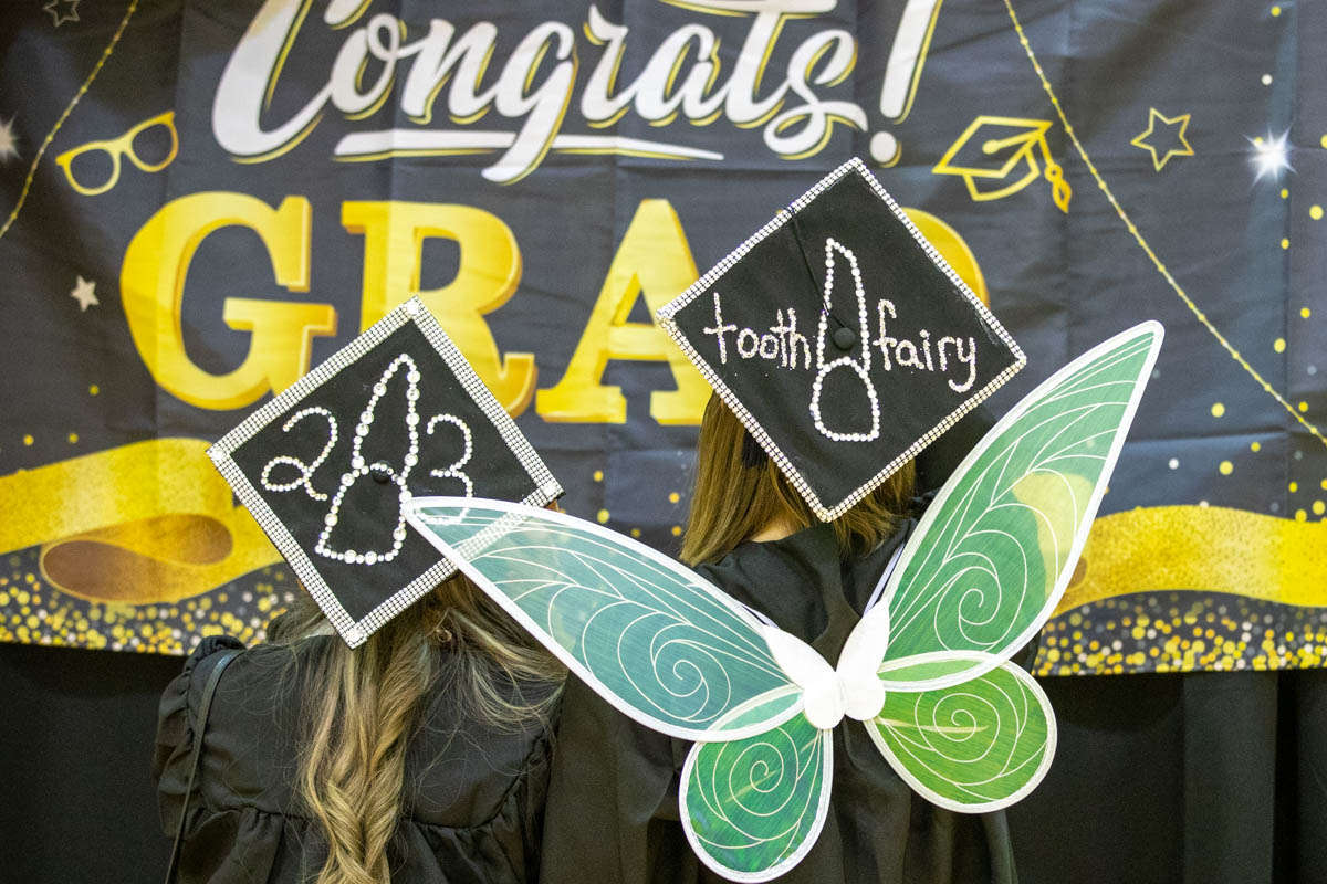 Two women dressed in graduation gowns