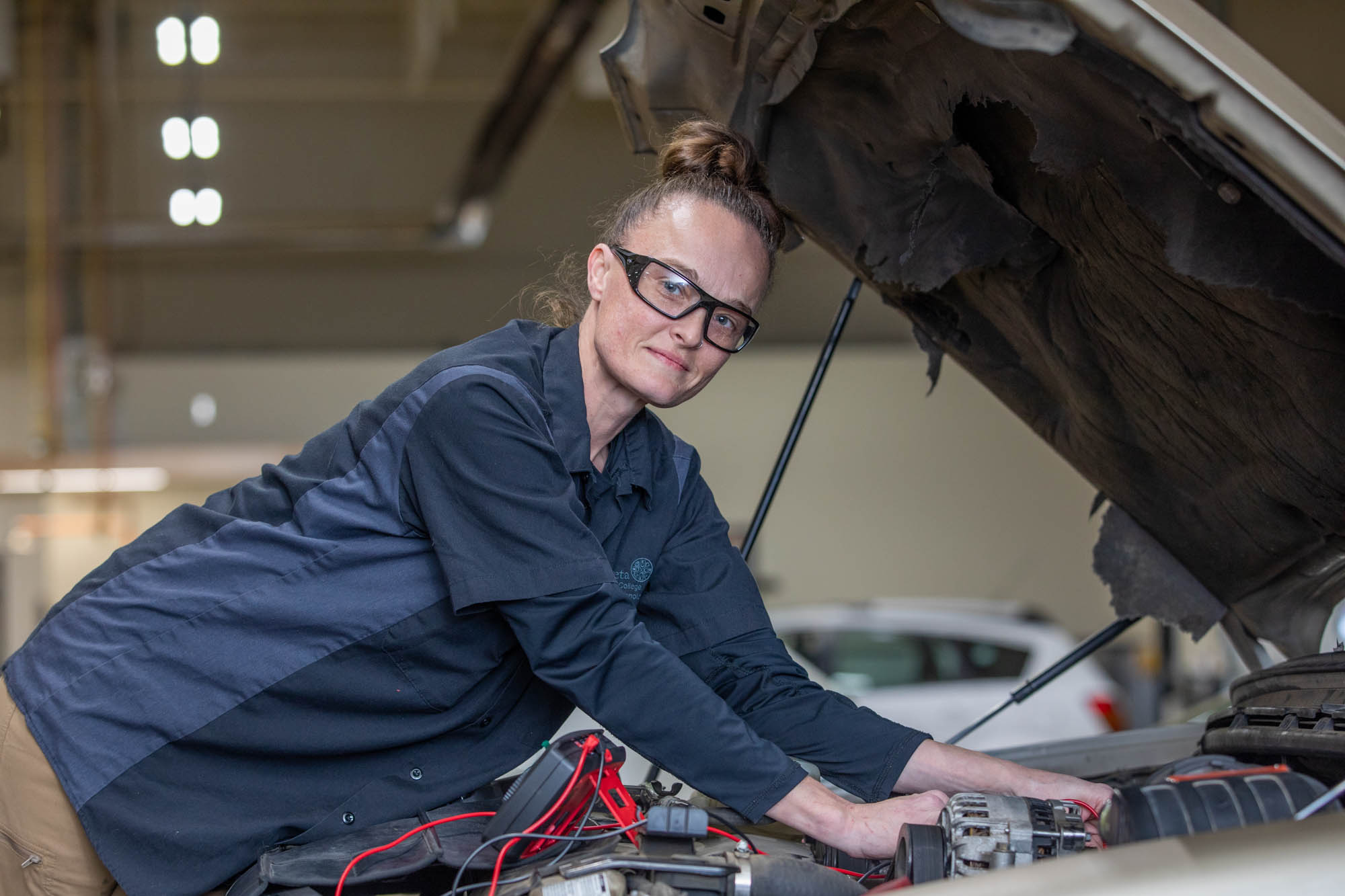 Woman testing battery on car