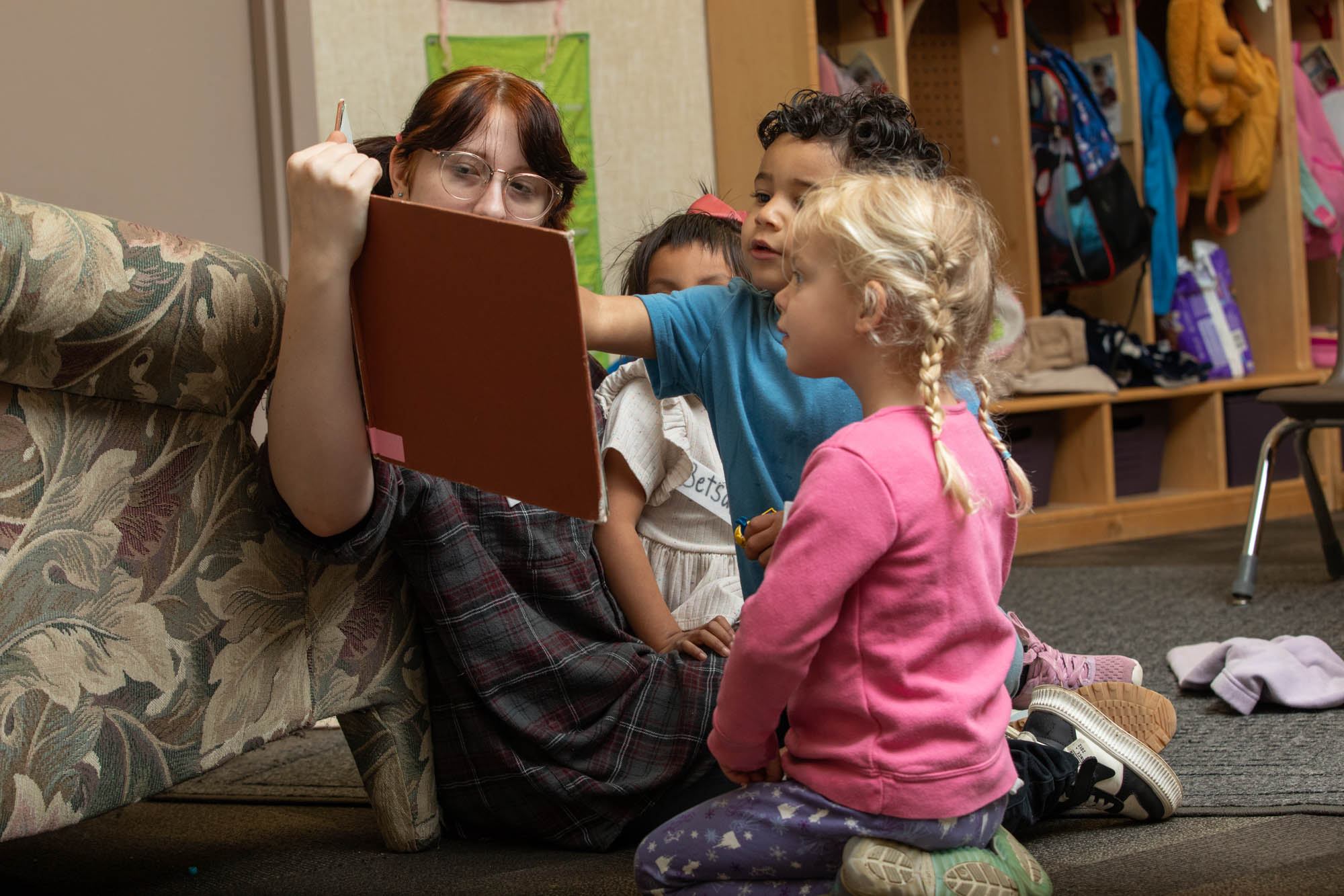 Woman reading to several small children