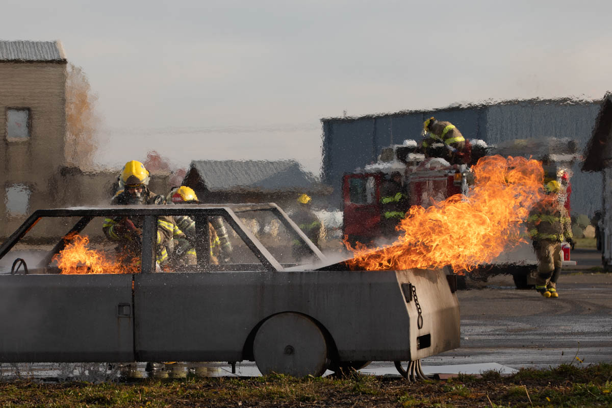 Fire fighters extinguishing a car fire