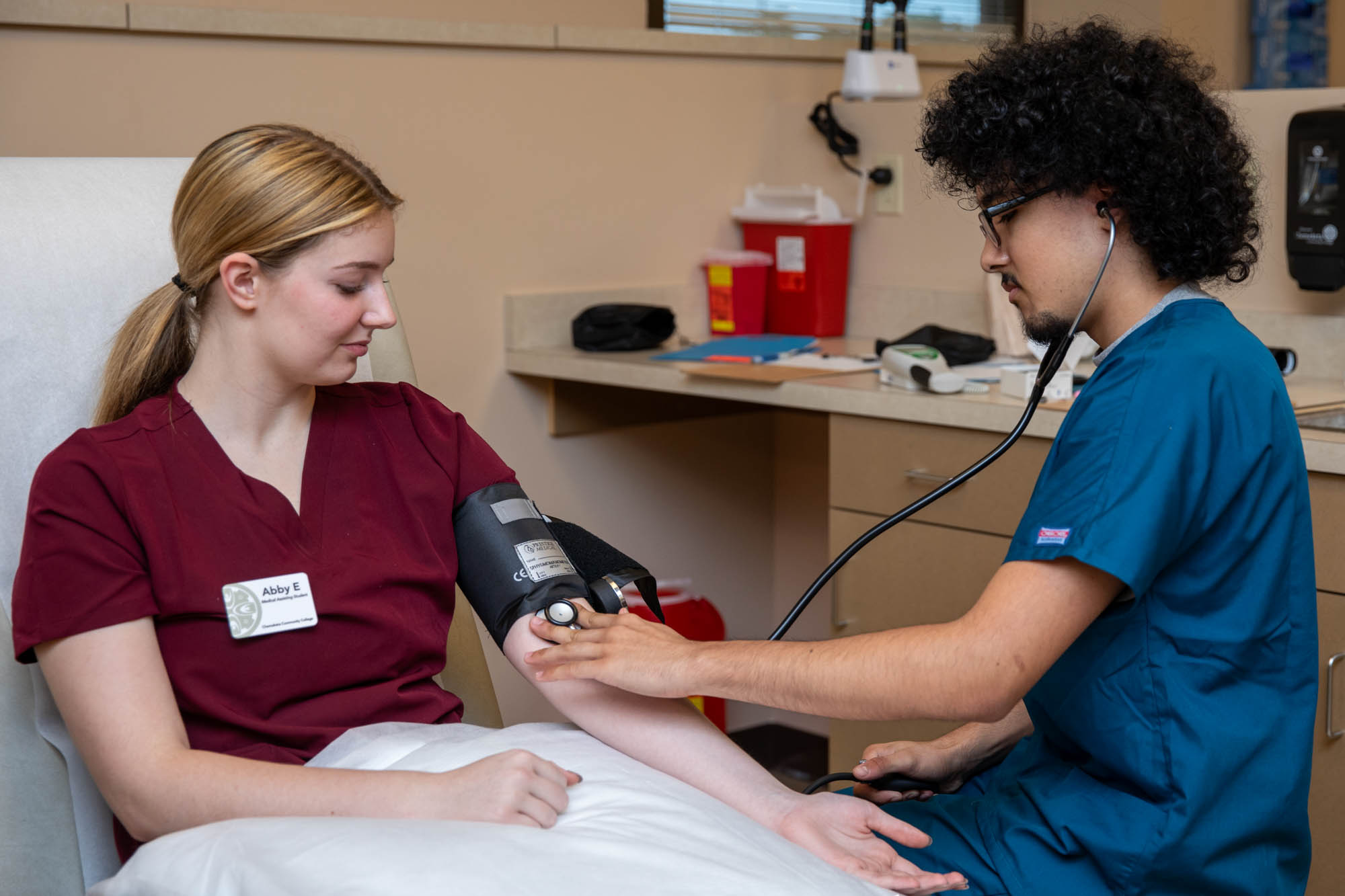 Student and faculty practicing needle sticks